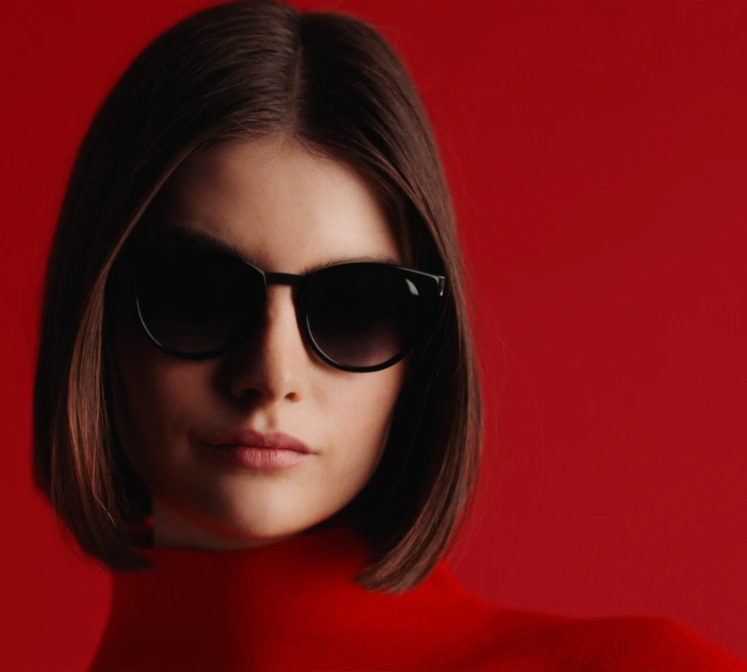 Editorial red portrait as brand visual beside product UI