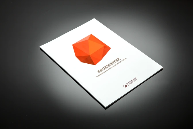 Print: ROCKMASTER brochure with orange polygon logo on white cover